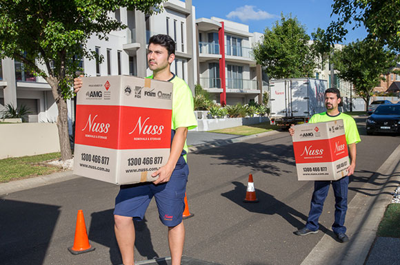Removalists loading truck with boxes
