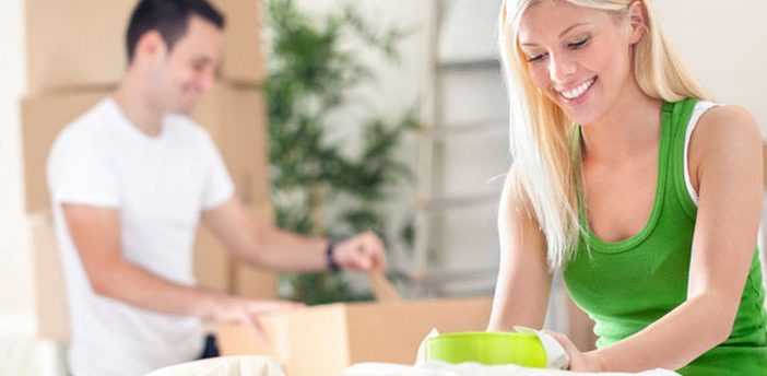 Young couple packing boxes to move to the city