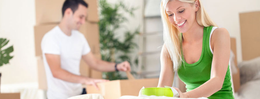 Young couple packing boxes to move to the city