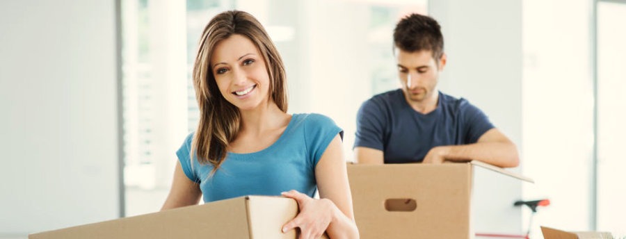 young couple packing boxes for moving overseas