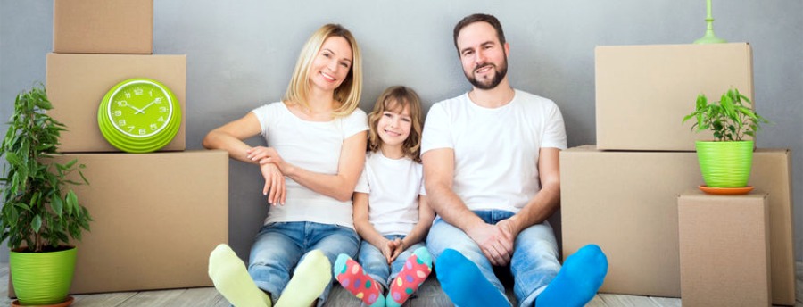 Family sitting on floor with moving boxes