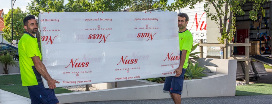 professional removalists moving a large table safely