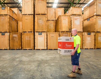 Man in high vis moving Nuss Removals box